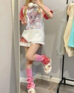 Printed pink kawaii t-shirt with a cute anime design, worn by a person.