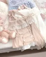 Close-up of a beige himekaji aesthetic sweater with off-shoulder design and lace details.