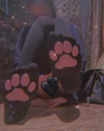 Black cat paw socks on feet, featuring pink paw prints. Comfortable cat paw socks.
