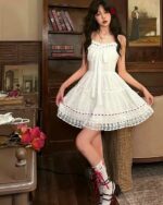 Lolita white laced dress in a cottagecore style, featuring lace details and a ruffled skirt.