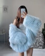 Light blue puffy hooded coat displayed in a room setting.