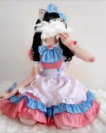 A pink and blue kawaii maid dress, featuring ruffles and a cat-ear headband. This kawaii maid dress is perfect for cosplay.