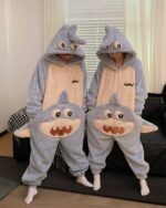 Two people wearing a blue dino-shark jumpsuit with a hood and attached fins.