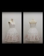 White gothic lolita dress on a mannequin, featuring intricate floral embroidery and a delicate lace trim.