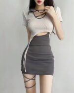 Cream and black coquette aesthetic dress with tie details and leg wraps.