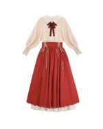French-style cottagecore dress featuring a cream blouse and a long, red skirt with lace details.