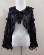 Black fairycore sleeve bow attached to a sheer top on a mannequin.