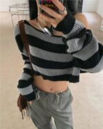 Black and white striped retro aesthetic sweater with off-the-shoulder neckline.