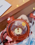 Kawaii bear straw bottle with a clear lid and carrying strap.