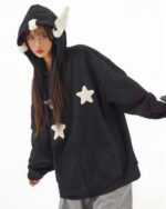 Black harajuku hoodie with star embroidery and feather details.