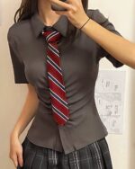 Grey shirt and plaid skirt preppy aesthetic uniform with striped tie.