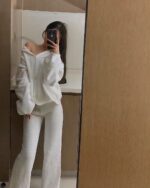 White fluffy bunny pajamas set worn by a person in a mirror reflection.