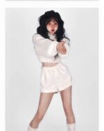 Model wearing a white kawaii fluffy pajamas set, featuring a cropped top and shorts.