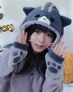 Person wearing a gray Kawaii Neko Atsume hoodie with paw details and cat ears.