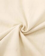 Close-up of a beige kitten besties t-shirt fabric, showing a crease.