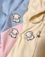 Two puppy hoodies – one blue and one pink – featuring embroidered dog and bone designs. A cute puppy hoodie.