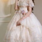 Close-up of a pink floral lolita dress with ruffles and lace details, featuring a puffy skirt.