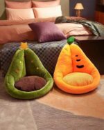 Two kawaii fruit cushions, a green pear and an orange carrot, displayed on a bed.