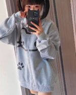 Cute Neko print hoodie, gray zip-up jacket with cat and paw motifs.