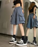 Blue korean aesthetic shorts with pockets, worn by a person.