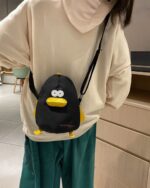 A black cartoon messenger bag featuring a penguin design, a cartoon messenger bag.