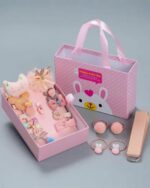 Pink kawaii diy material gift bag filled with hair accessories.