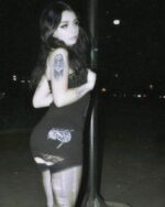 Woman wearing a Skull Printed Tight Dress - Gothic aesthetic, featuring a distressed lace trim and leggings.