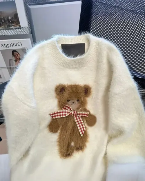Cream-colored autumn bear sweater with a red and white checkered bow. Cottagecore aesthetic clothing.