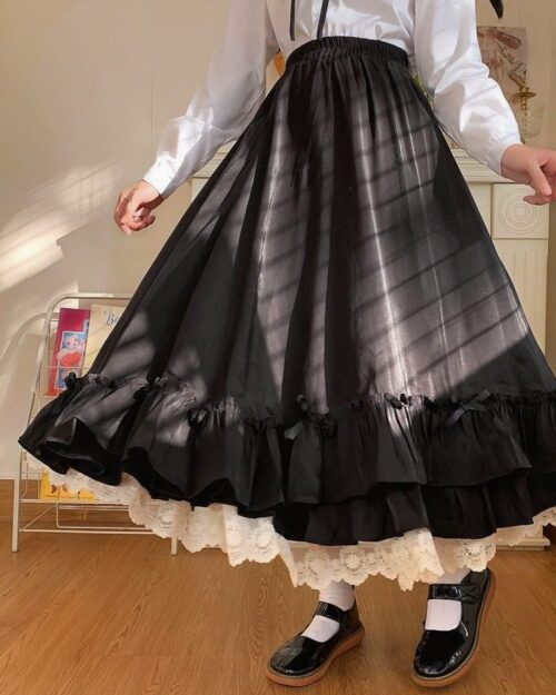Black gothic lolita ruffled skirt with white lace trim, long and flowing.
