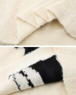 Close-up view of a cat embroidered sweater, showcasing the stitching details.