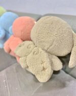 Close-up of a kawaii space sheep plushie, soft texture.