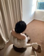 Y2k aesthetic top layered with a fluffy faux fur shawl.