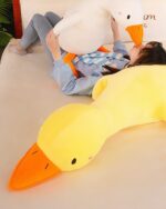 Waddles and Puddles Goose Plush toy, a soft yellow duck plush on a couch.