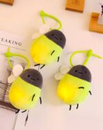 Cute firefly plush keychain with green accents and glowing tails.