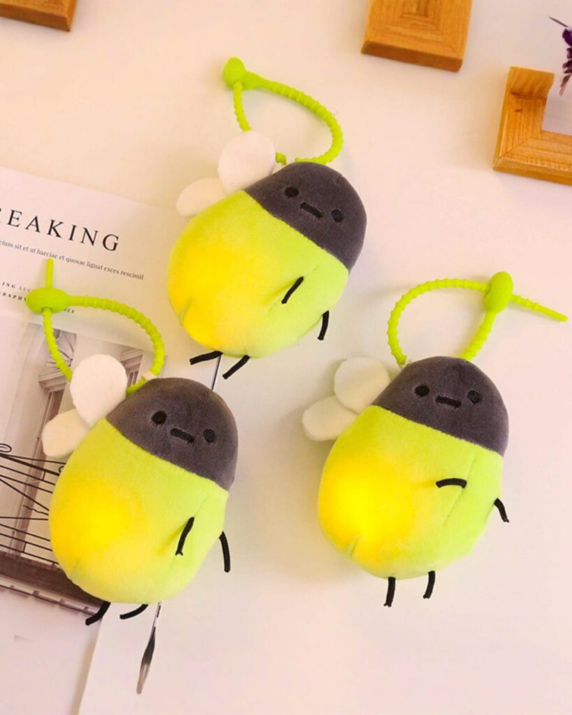 Cute firefly plush keychain with green accents and glowing tails.