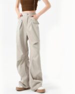 Rivet Design Loose Pants - Korean aesthetic pants in beige, featuring a wide-leg silhouette and button details.