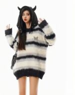 Striped fluffy Korean aesthetic sweater featuring a cream and black colorway, worn by a model.
