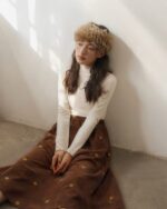 Brown corduroy retro aesthetic skirt with embroidered floral details.