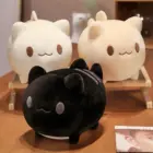 Two round neko plushies, one white and one black, displayed on a table.