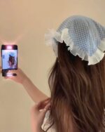 Retro triangle headscarf in blue gingham with ruffles, a charming hair accessory.