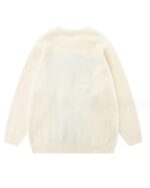 Cream-colored cat embroidered sweater, loose knit design.