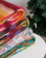 Close-up of multiple fluffy kawaii rainbow scarves in various colors, showcasing vibrant textures and patterns.