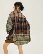 Back view of a y2k aesthetic plaid shirt with layered colors and distressed details.