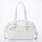 White japanese schoolbag with heart detail, top handle and shoulder strap.