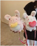 Two pink and white chibi loli handbags with straps, resembling plush toys.