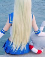 Back view of a person wearing a shimakaze uniform set, blue sailor top, and white socks.
