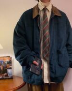 Korean college jacket in a dark corduroy color, worn by a person with a plaid tie and pants.