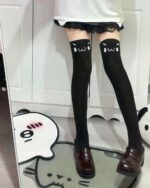 Black kaomoji cute stockings with emoji accents on thigh-high socks.