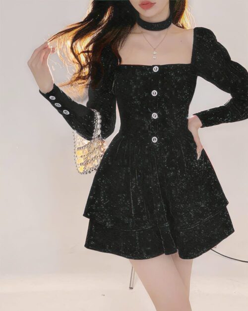 Black festive velvet dress with long sleeves and button details.