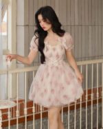 Floral pink dress featuring a cottagecore aesthetic, with floral details and a delicate tulle skirt.